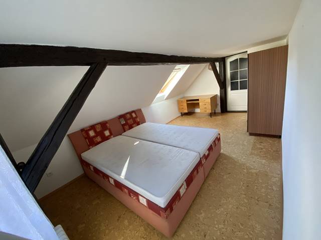 Ložnice v podkroví orientovaná na severovýchod. Střešní okno je opatřeno roletou se 100% nepropustností světla.